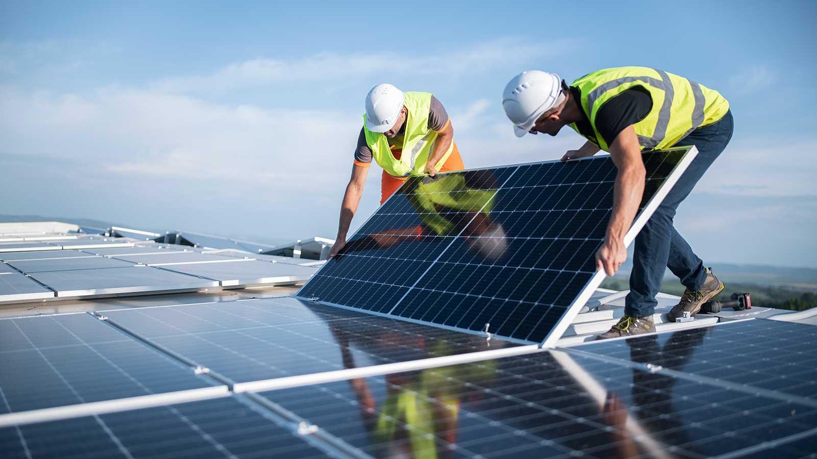 Engineers installing solar panels representing civil environmental engineering program at Clarkson university